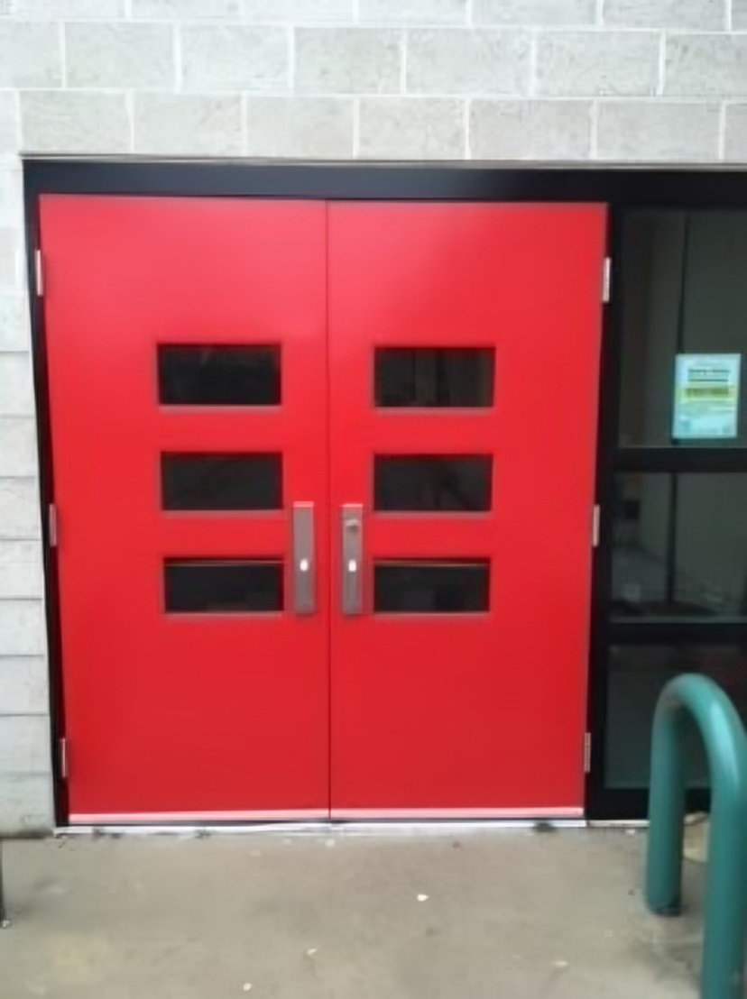 Albuquerque Public Schools painting project — freshly painted red double entry doors